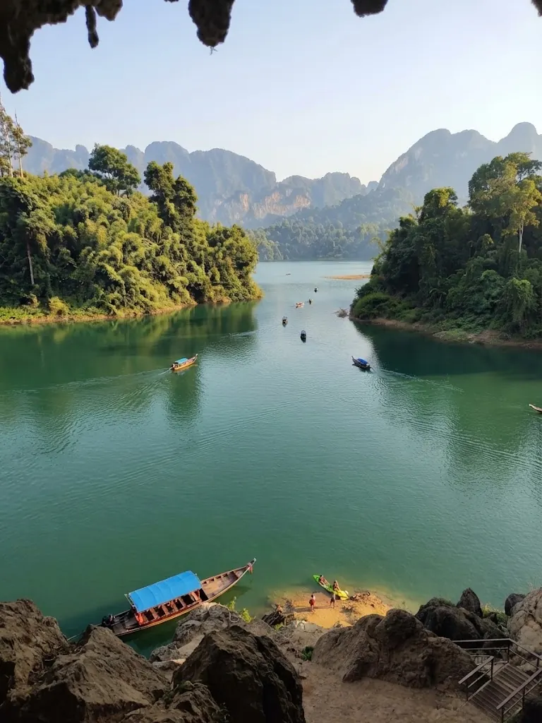 View from a cave mouth over the lake and moored boats
