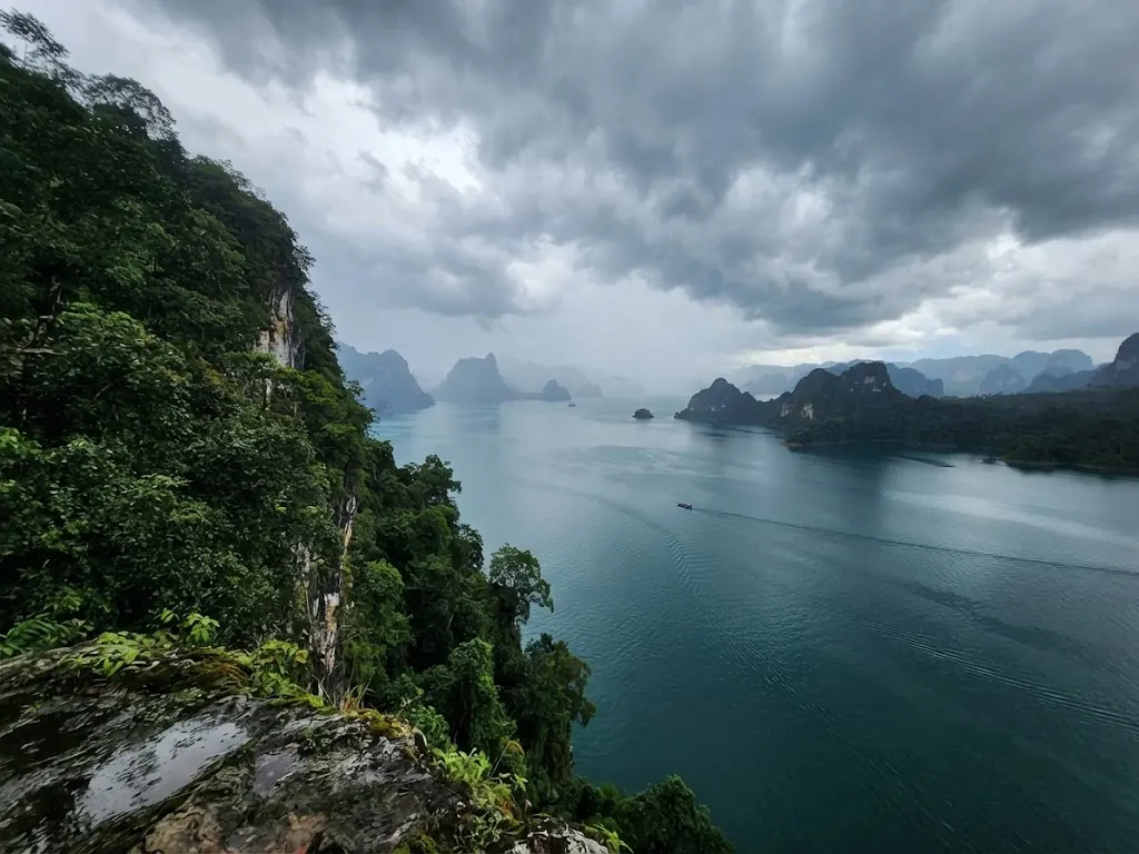 Storm clouds building over Cheow Lan Lake, seen from a jungle-covered cliff