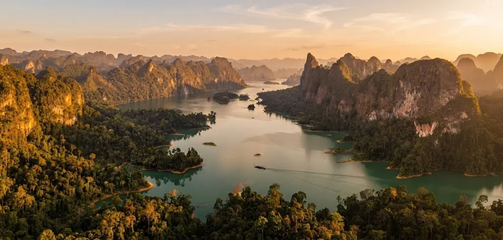Aerial view of lake arms winding between karst ridges at sunset in Khao Sok